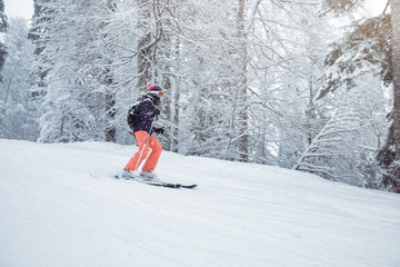 Young woman skiing under snowfall