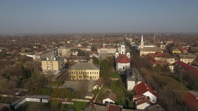 Aerial shot of city center in Serbian town Becej. Two churches, orthodox and catholic