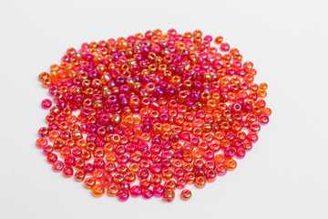 heap with tiny red iridescent glass beads for embroidery