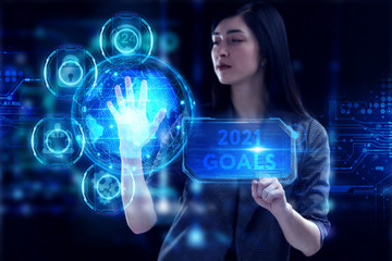 Business, Technology, Internet and network concept. Young businessman working on a virtual screen of the future and sees the inscription: 2021 goals