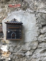 old stone wall with letter box or mailbox