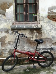 old bicycle in front of an old brick wall