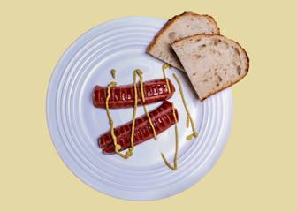 Sausages and bread with  mustard on plate isolated on yellow