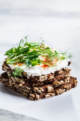 Toast with cream cheese and seedlings. Healthy food concept.
