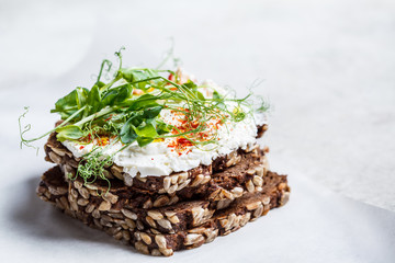 Toast with cream cheese and seedlings. Healthy food concept.
