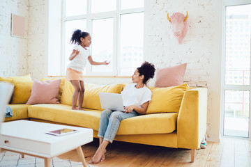 Black daughter trying playing with mommy