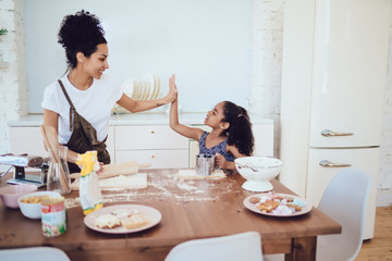 Mother and child giving high five during cooking