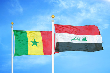 Senegal and Iraq two flags on flagpoles and blue cloudy sky