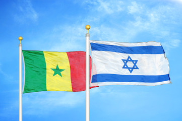 Senegal and Israel two flags on flagpoles and blue cloudy sky