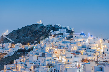 The chora - capital with traditional white houses of Serifos island Aegean Cyclades Greece against a blue sky during blue hour