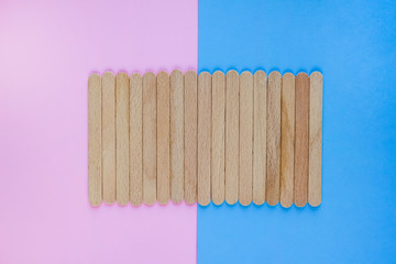Clean wooden or bamboo planks or sticks on trendy pink and blue background with copy space