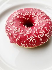 Delicious berry donut on a plate macro