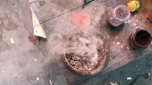 Smoke coming out of a pot on a table.