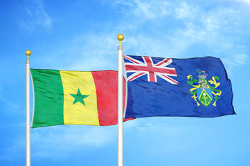 Senegal and Pitcairn Islands two flags on flagpoles and blue cloudy sky