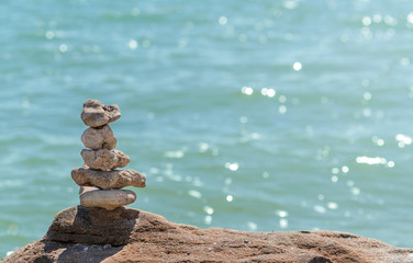 Zen concept. Object made of stone on the beach. Stone pyramid for meditation. Harmony and Meditation. Zen stones.
