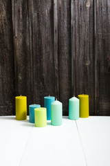 candles on white table, old weathered wooden wall background
