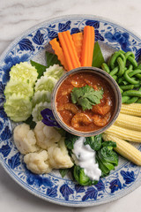 Close up top view of dried shrimp chili dip with variety of vegetable. Traiditional food of Phuket Thailand.