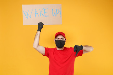 Delivery man in red cap t-shirt uniform face mask gloves hold broadsheet placard isolated on yellow background studio Guy employee working courier Service pandemic coronavirus virus 2019-ncov concept.