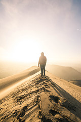 man walking in desert