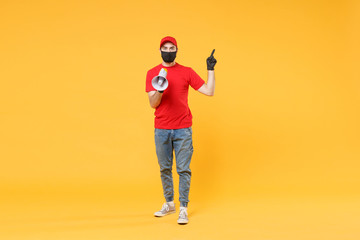 Delivery man in red cap blank t-shirt uniform mask gloves isolated on yellow background studio Guy fun employee working courier scream in megaphone Service pandemic coronavirus virus 2019-ncov concept