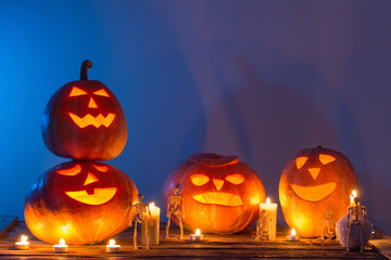 halloween pumpkins with candles on wooden table