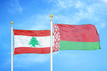 Lebanon and Belarus  two flags on flagpoles and blue cloudy sky