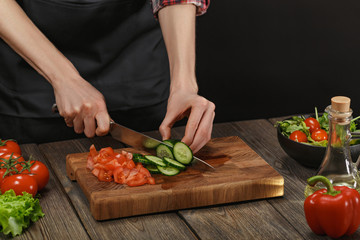 Woman cooking fresh vegetable salad. Female hands. Diet concept for healthy lifestyle with copyspace.