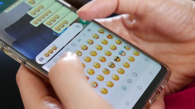 woman sends funny emoticons on an instant messaging application