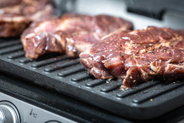 Fresh marbled meat on electric grill cooked 