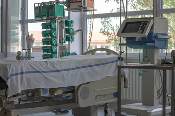 Intensive care unit in hospital, bed with monitor, ventilator, a place where can be  treated patients with pneumonia caused by coronavirus covid 19.