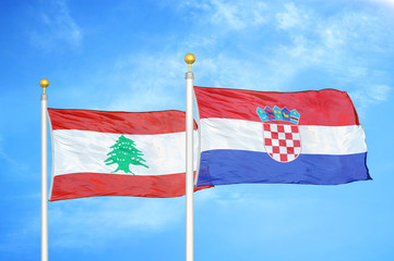 Lebanon and Croatia two flags on flagpoles and blue cloudy sky