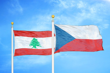 Lebanon and Czech Republic two flags on flagpoles and blue cloudy sky