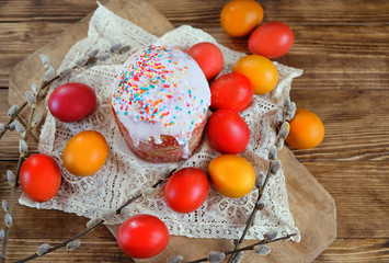 Easter holiday concept. colorful eggs and Easter cake on wooden table. top view. copy space 