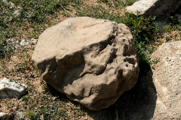 Large gravel from the mountains that are outdoors on the ground.