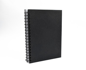 Portrait of an isolated black colored note paper in front of a white background