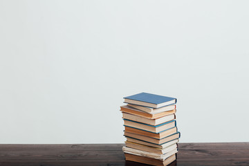 many stacks of educational books at home preparing for exams on a white background