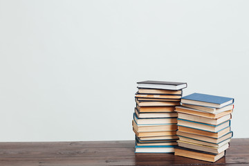 many stacks of educational books at home preparing for exams on a white background