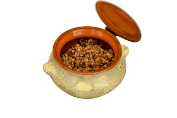 Buckwheat porridge in a clay pot on a white background. Isolated.