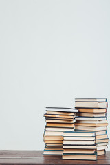many stacks of educational books at home preparing for exams on a white background