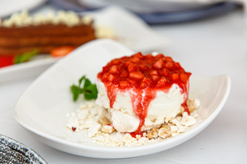 Pavlova dessert with strawberries on a white plate