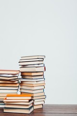 many stacks of educational books at home preparing for exams on a white background