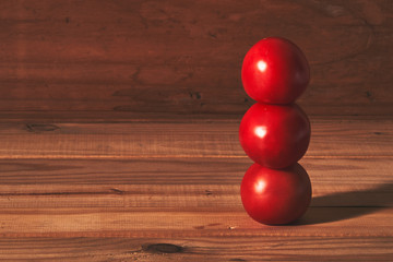 red tomatoes stacked on wood