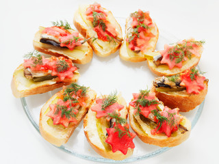 Snack sandwich with sprats cucumber and tomatoes and dill. Delicious sandwiches on a plate.