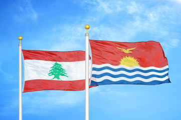 Lebanon and Kiribati two flags on flagpoles and blue cloudy sky