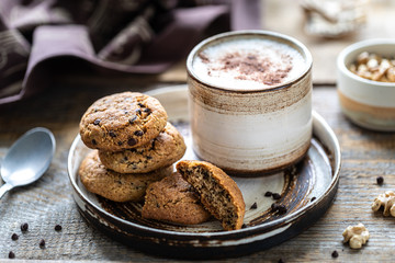 Homemade cookies with nuts and coffee in a ceramic cup