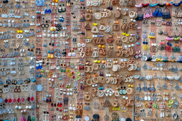Colorful handmade earrings for sale for tourists at the street market in Hoi An old town, Vietnam