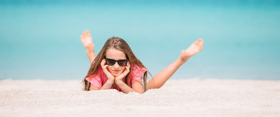 Adorable active little girl at beach during summer vacation