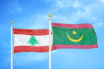Lebanon and Mauritania two flags on flagpoles and blue cloudy sky