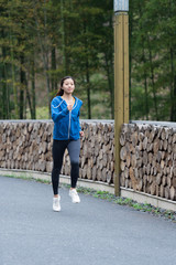 A young Asian woman is running