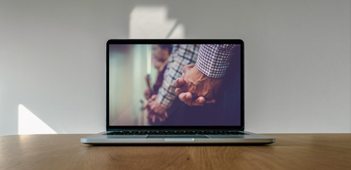 Worship from home, Online live church for sunday service, Laptop screen with close up prayer hands, quarantine for Covid 19 situation